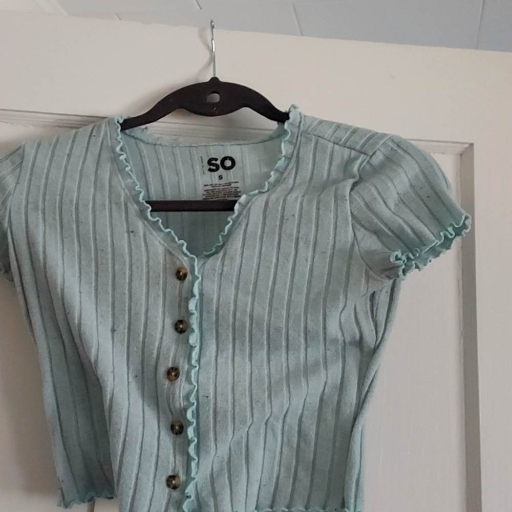 A light blue, v neck top